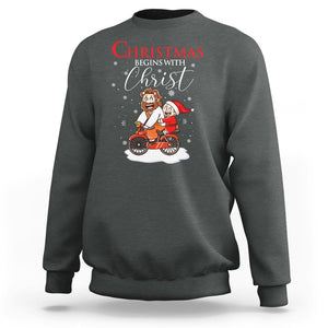 Christmas Begins With Christ Jesus Santa Riding Bicycle Sweatshirt TS09 Dark Heather Printyourwear