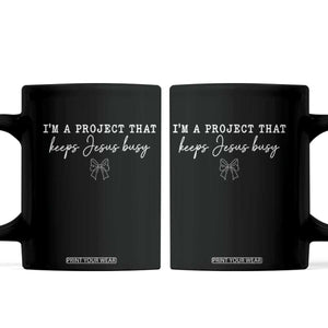 I am a Project That Keeps Jesus Busy Coquette Bow Coffee Mug Christian Faith Humor TS02 Black Print Your Wear