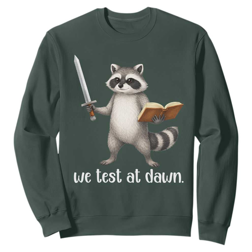 We Test At Dawn Raccoon Warrior Sweatshirt Funny Student Teacher Exam Motivation TS02 Dark Forest Green Print Your Wear