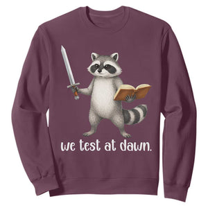 We Test At Dawn Raccoon Warrior Sweatshirt Funny Student Teacher Exam Motivation TS02 Maroon Print Your Wear