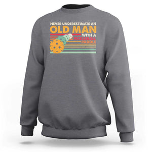 Funny Pickleball Sweatshirt Never Underestimate An Old Man With A Pickleball Paddle TS09 Charcoal Print Your Wear