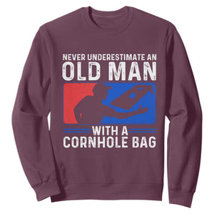 Funny Cornhole Player Sweatshirt Never Underestimate An Old Man With A Cornhole Bag TS10 Maroon Print Your Wear