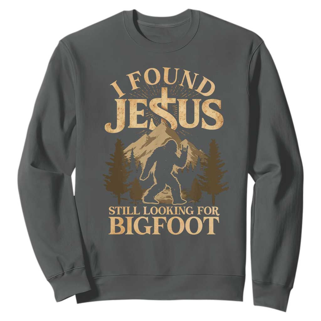 I Found Jesus Still Looking For Bigfoot Sweatshirt Funny Christian Sasquatch Vintage Mountain TS11 Dark Heather Print Your Wear