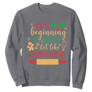 Funny Christmas Baker Sweatshirt It's Beginning To Taste A Lot Like Christmas Gingerbread TS11 Charcoal Print Your Wear