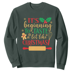 Funny Christmas Baker Sweatshirt It's Beginning To Taste A Lot Like Christmas Gingerbread TS11 Dark Forest Green Print Your Wear