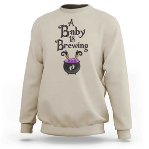 Funny Halloween Pregnancy Announcement Sweatshirt A Baby Is Brewing Witch Cauldron Footprint Pregnant Baby TS11 Sand Print Your Wear