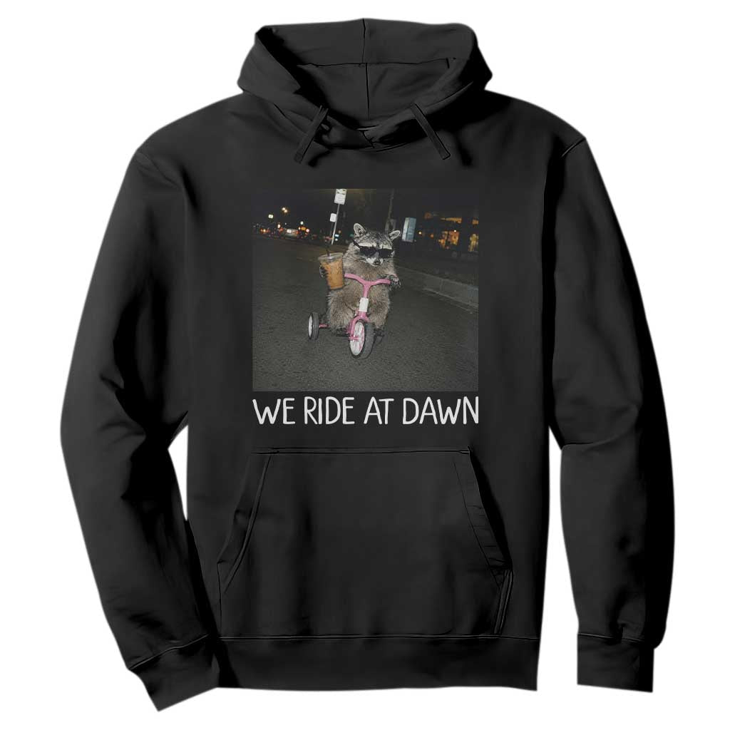 We Ride at Dawn Hoodie Funny Racoon Riding Tricycle Chaotic Meme TS14 Black Print Your Wear