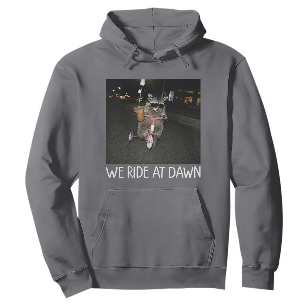 We Ride at Dawn Hoodie Funny Racoon Riding Tricycle Chaotic Meme TS14 Charcoal Print Your Wear
