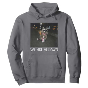 We Ride at Dawn Hoodie Funny Racoon Riding Tricycle Chaotic Meme TS14 Charcoal Print Your Wear