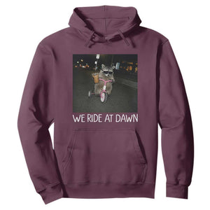 We Ride at Dawn Hoodie Funny Racoon Riding Tricycle Chaotic Meme TS14 Maroon Print Your Wear
