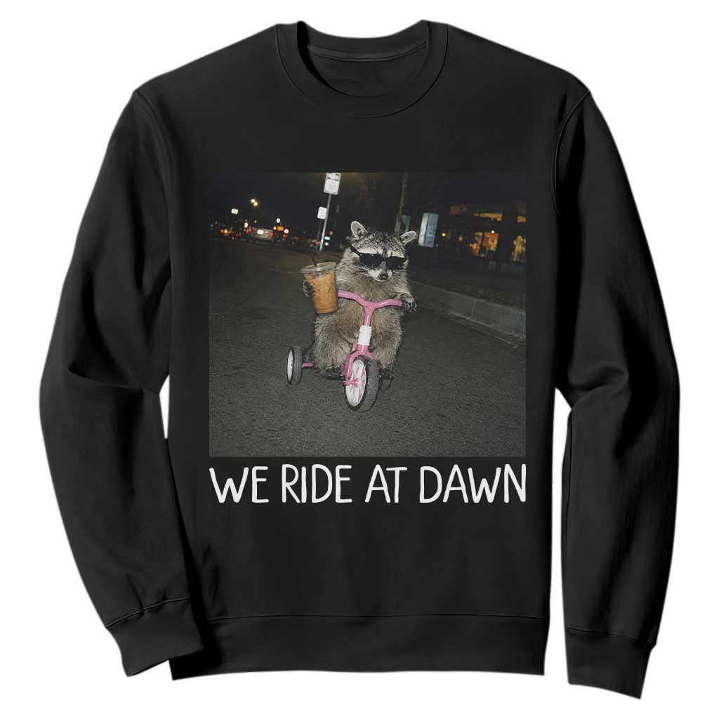 We Ride at Dawn Sweatshirt Funny Racoon Riding Tricycle Chaotic Meme TS14 Black Print Your Wear